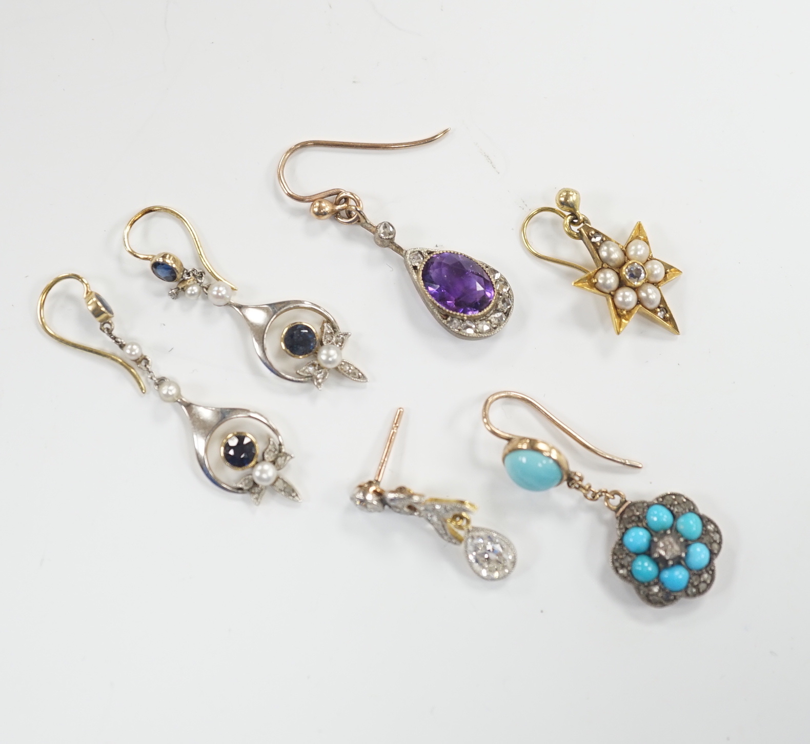 A group of four assorted Edwardian and later single earrings, including amethyst and diamond, turquoise and diamond, seed pearl and diamond cluster and pear shape diamond drop, 21mm and a pair of sapphire, seed pearl and